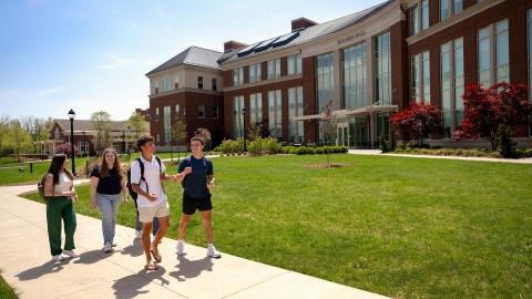 Students walk in front of Holmes Hall