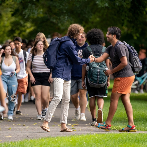 Students handshake on the first day of classes.