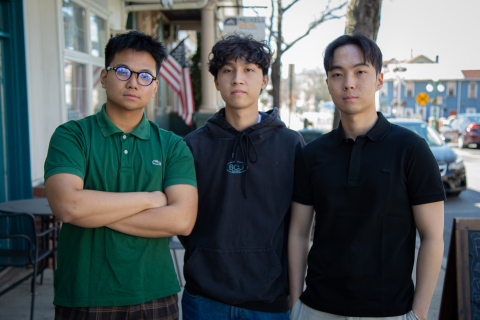 BizPitch, Duy Le '27 (L), Hung Ngo '26, Chang Min Bark '26 (R) standing downtown
