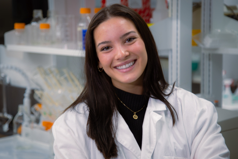 Standing in lab, Elizabeth Malley '26 - First Place $6,000 - ThermaIV