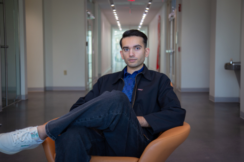 Farhaj Shahid '26 - Finalist $1,500 - Bison Match , Sitting on a chair in the hallway