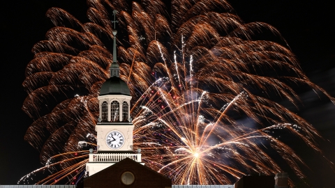 Fireworks explode over the clock tower at Bertrand Library during the night. 