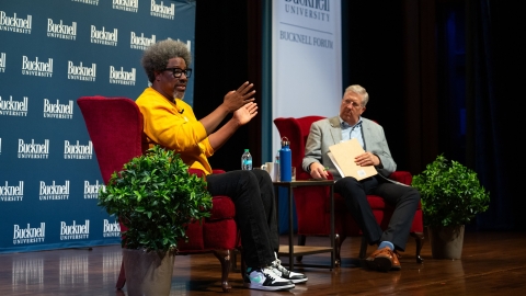 W. Kamau Bell speaks with President John Bravman on the Weis Center for the Performing Arts stage.