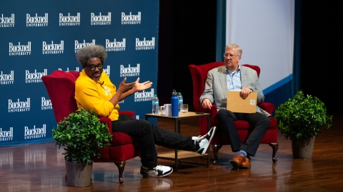 W. Kamau Bell speaks with President John Bravman on the Weis Center for the Performing Arts stage.