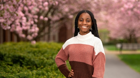 Deborah Gonkpah &#039;26 poses against a backdrop of cherry blossoms