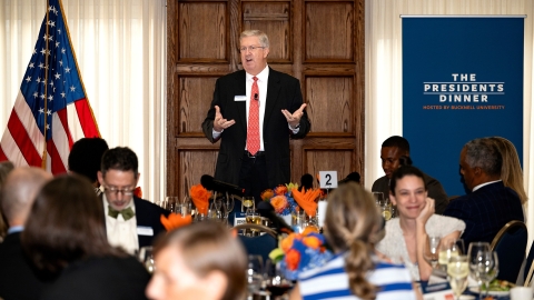 President John Bravman standing and speaking at The Presidents Dinner