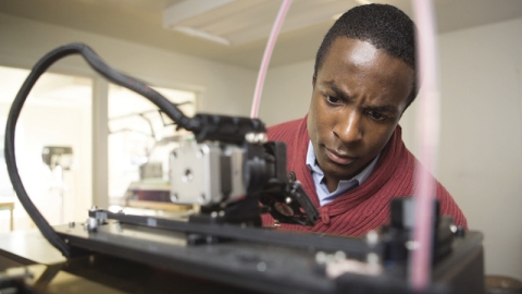 Person working at a 3D printer