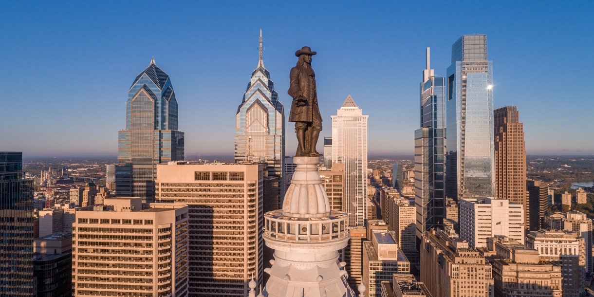 Aerial photo of the Philadelphia skyline with the William Penn statue in the foreground