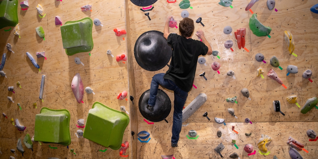 Person climbing up the climbing wall