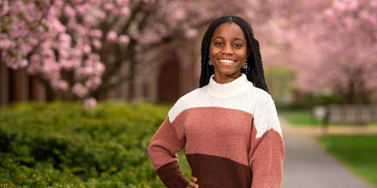 Deborah Gonkpah &#039;26 poses against a backdrop of cherry blossoms