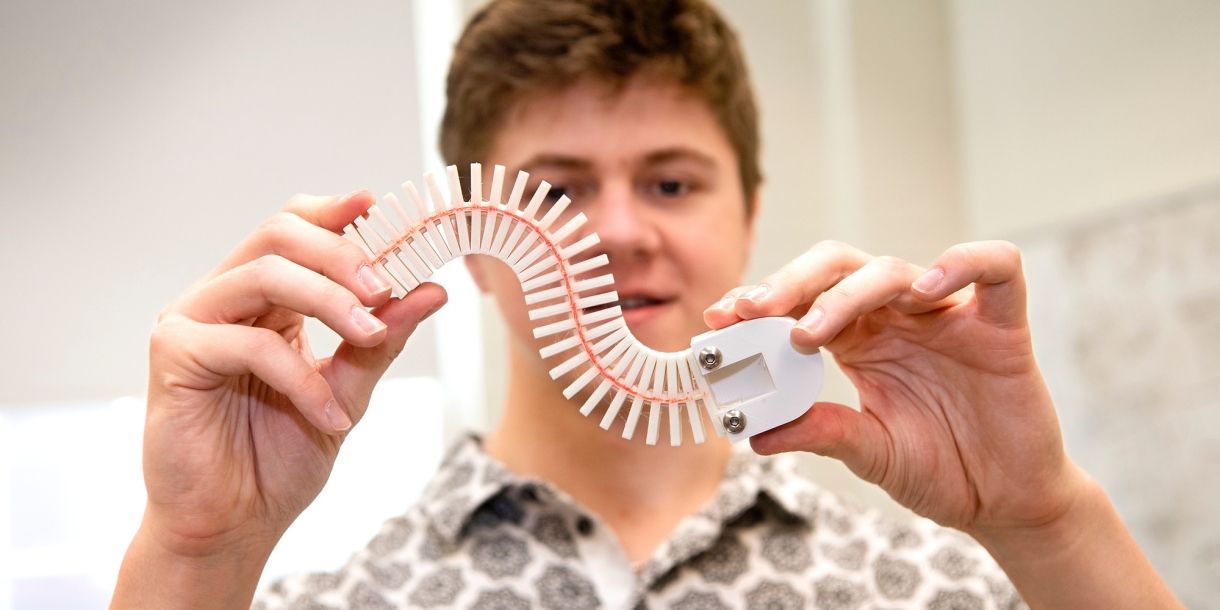 Caiden Covell '25 bends the spine of his robot