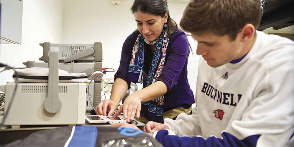 A professor and student work to make a solar powered backpack