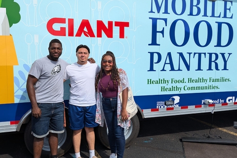 Ralf Cesar &#039;25, Elmer Cruz &#039;25 and Jahnia Treadwell &#039;25 stand in front of a Giant Mobile Food Pantry truck.