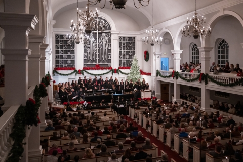 The interior of Rooke Chapel is filled with onlookers during the Christmas Candlelight Service.