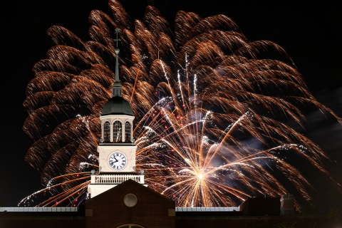 Fireworks explode over the clock tower at Bertrand Library during the night.