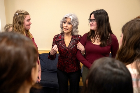 Jane Fonda stands arm in arm with a Bucknell student.