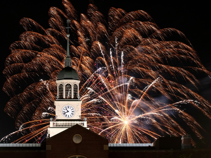 Fireworks explode over the clock tower at Bertrand Library during the night. 