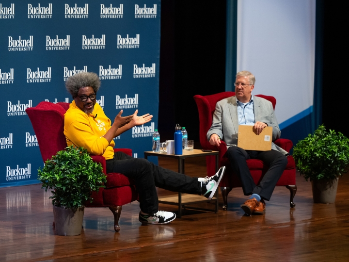 W. Kamau Bell speaks with President John Bravman on the Weis Center for the Performing Arts stage.