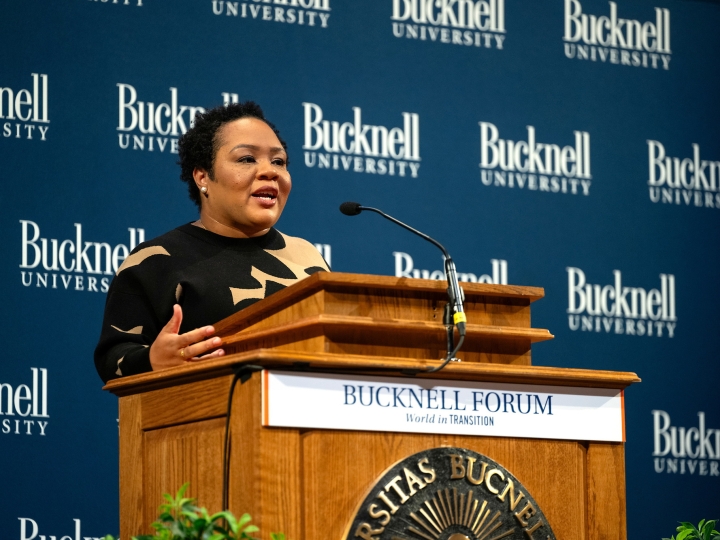 Yamiche Alcindor speaks at a podium during the Bucknell Forum.