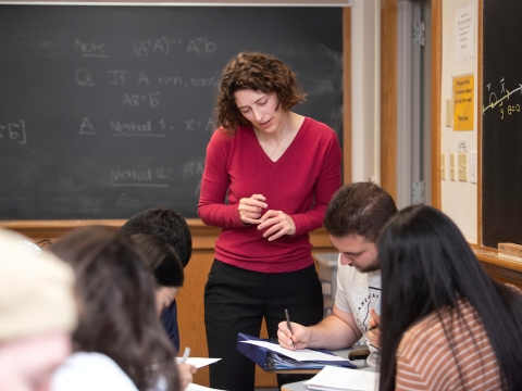 Professor Emily Dryden helping a group of students