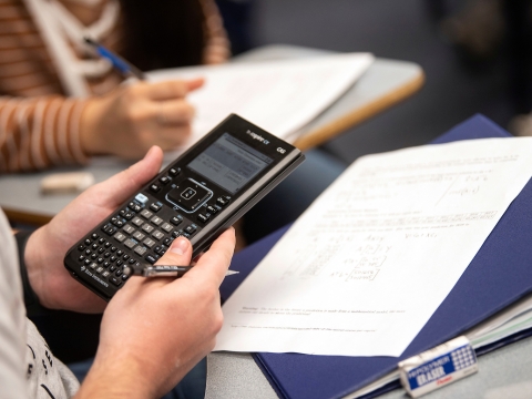 Student holding calculator