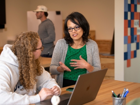 Professor Gabriela Diego with a student in a MIDE class