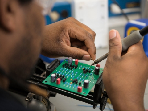 Student working on firefly circuit