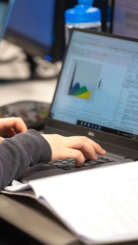 A student works on a graph on a laptop