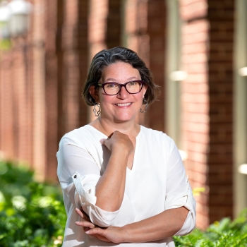 Portrait of Virginia Zimmerman outside of a brick building.