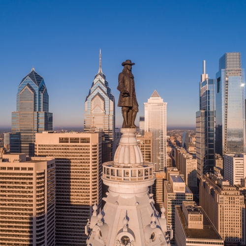 Aerial photo of the Philadelphia skyline with the William Penn statue in the foreground